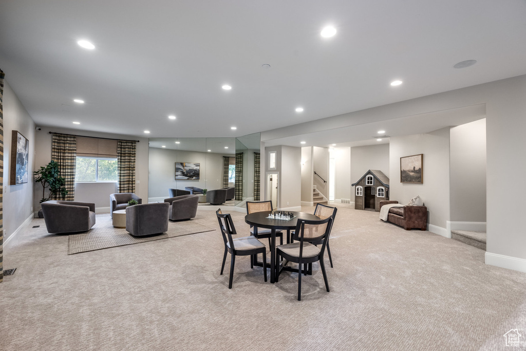 Dining room featuring stairway, recessed lighting, and light colored carpet