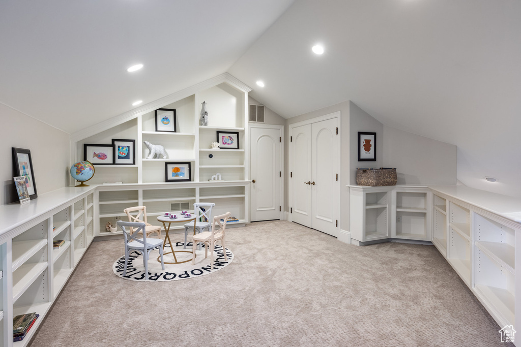 Interior space with carpet, visible vents, lofted ceiling, and recessed lighting
