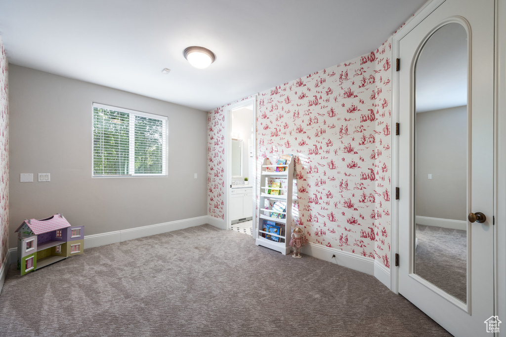 Rec room featuring wallpapered walls, baseboards, and carpet floors