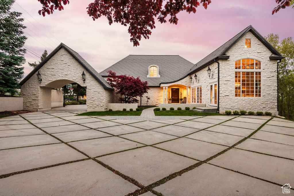 View of front of home featuring stone siding and a high end roof