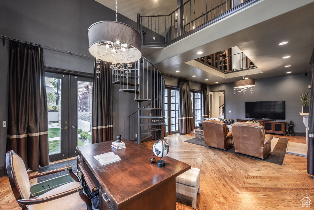 Dining area featuring stairs, a healthy amount of sunlight, french doors, and a high ceiling