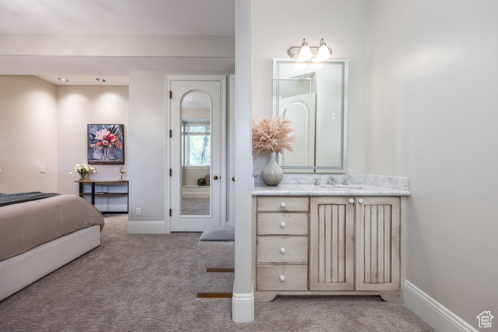 Bedroom with light carpet and baseboards