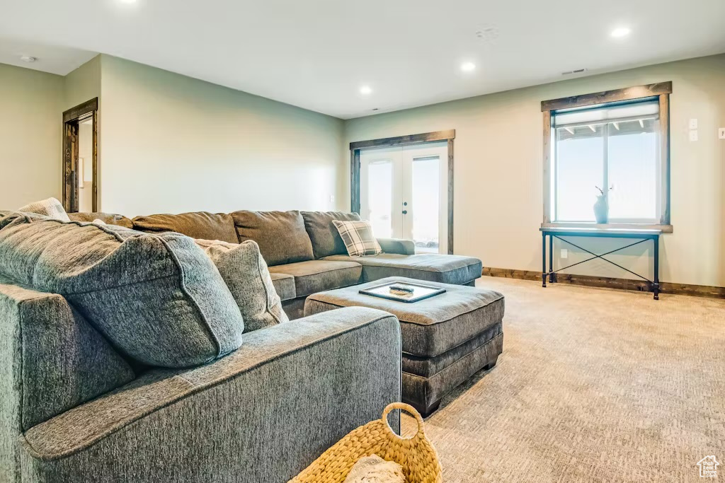 Carpeted living area featuring baseboards, a wealth of natural light, french doors, and recessed lighting