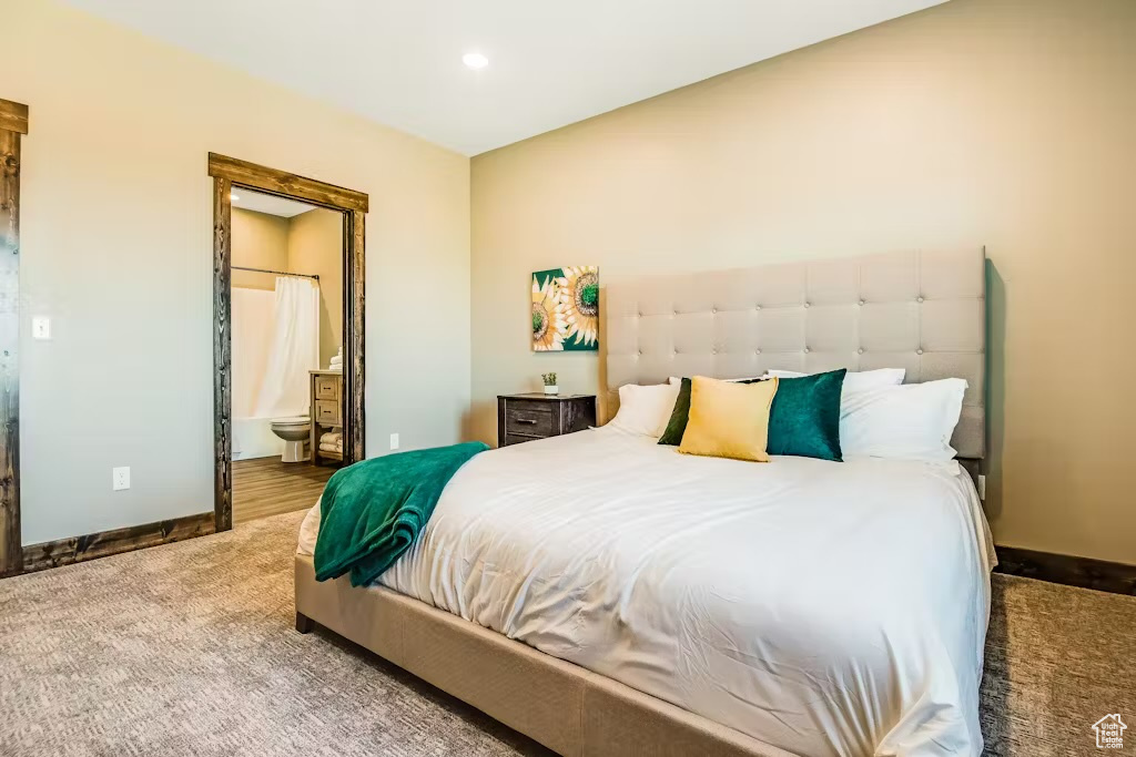 Bedroom featuring recessed lighting, connected bathroom, baseboards, and carpet floors