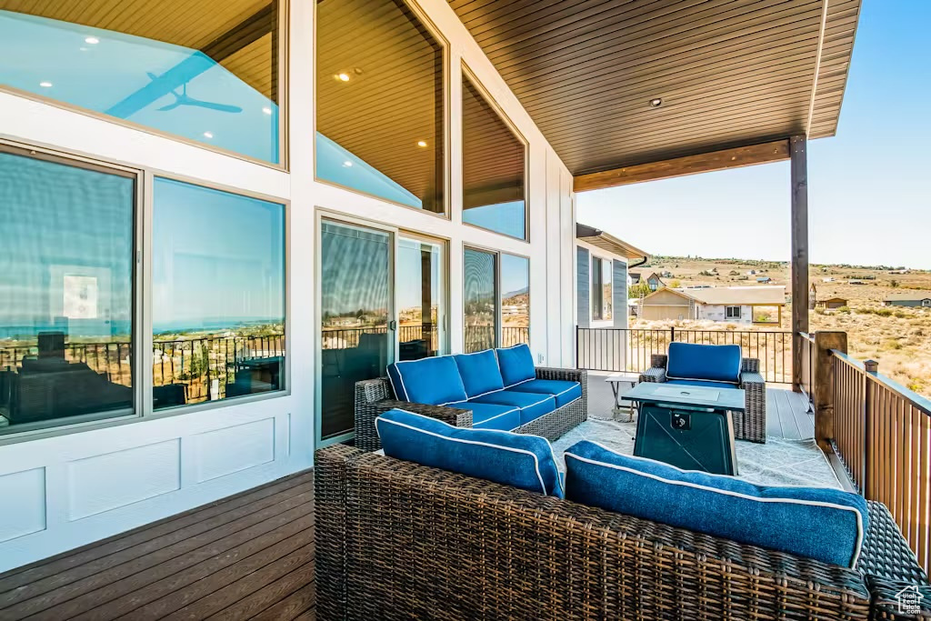 View of patio with an outdoor living space with a fire pit