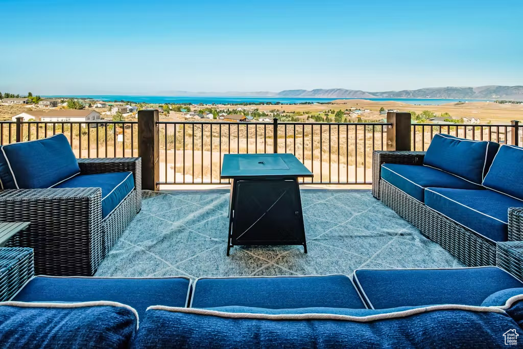View of patio with an outdoor hangout area and a mountain view