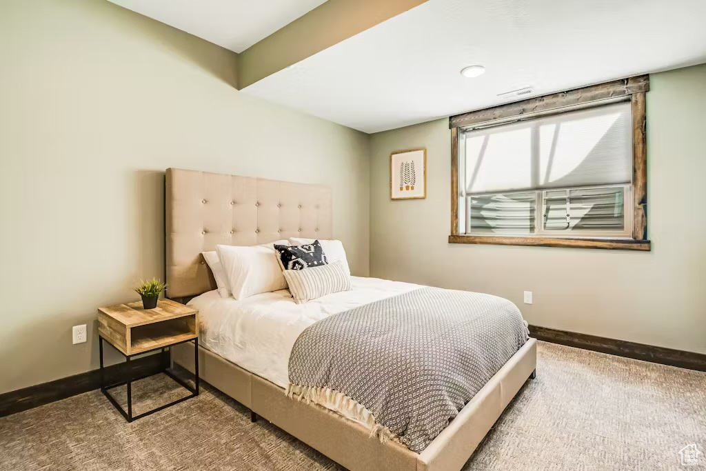Bedroom featuring baseboards and carpet floors