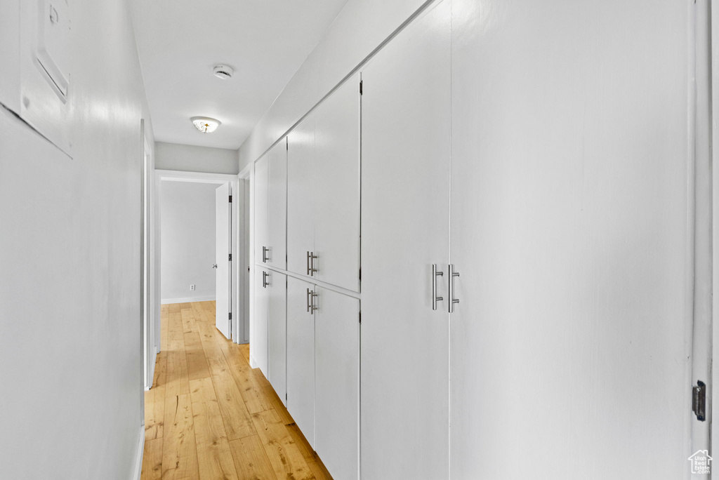 Hallway featuring light wood-style flooring
