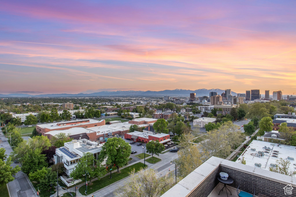 Aerial view at dusk of a mountain view and a view of city