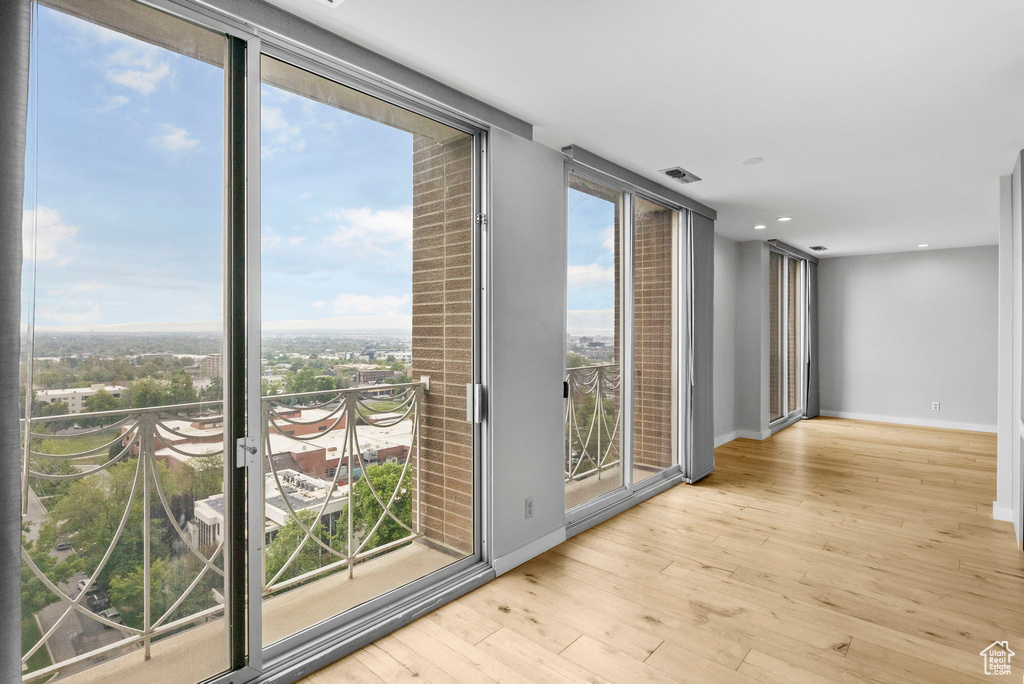 Interior space with recessed lighting, baseboards, visible vents, and wood finished floors