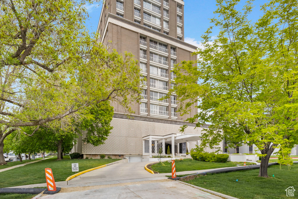 View of building exterior featuring concrete driveway