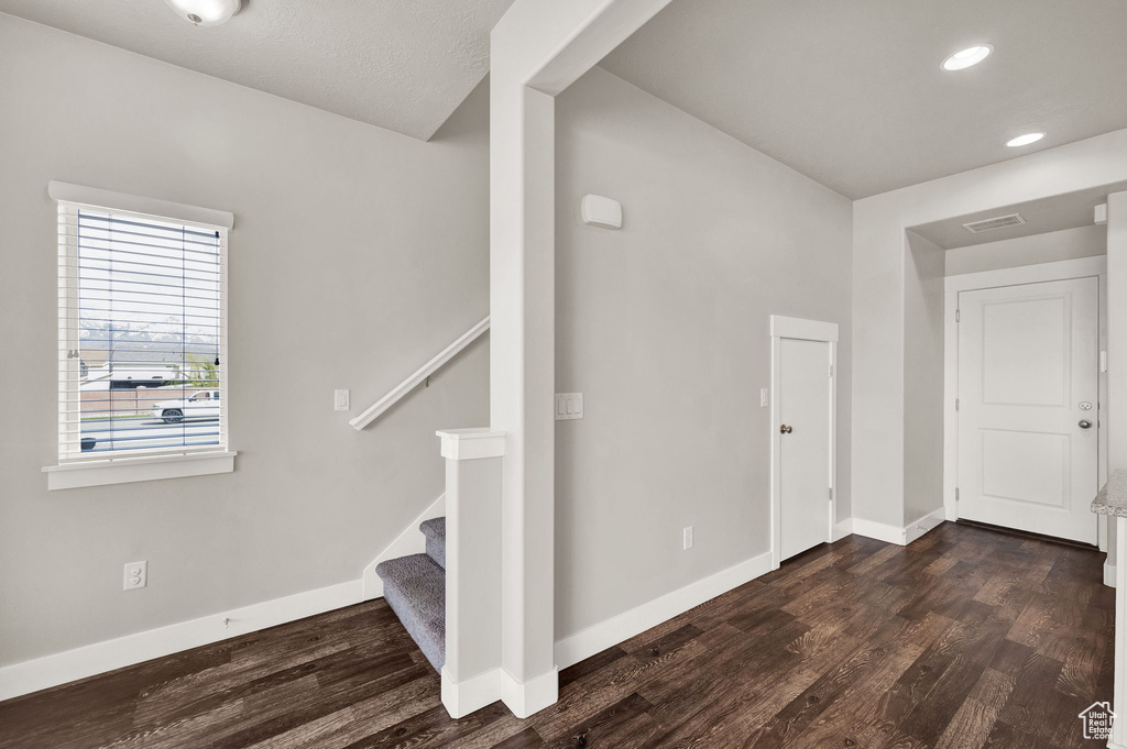 Stairs with baseboards, recessed lighting, visible vents, and wood finished floors