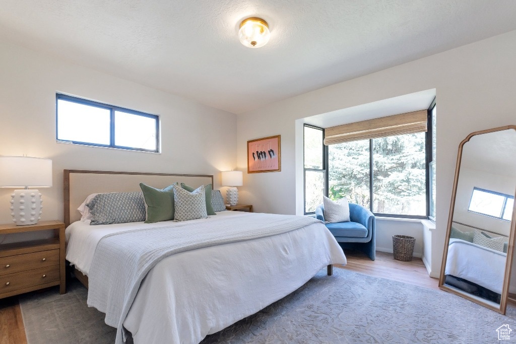 Bedroom featuring baseboards and wood finished floors