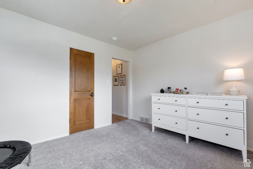 Bedroom featuring baseboards, light carpet, and visible vents