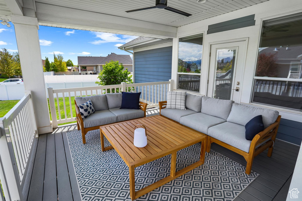 Deck featuring an outdoor hangout area and a ceiling fan