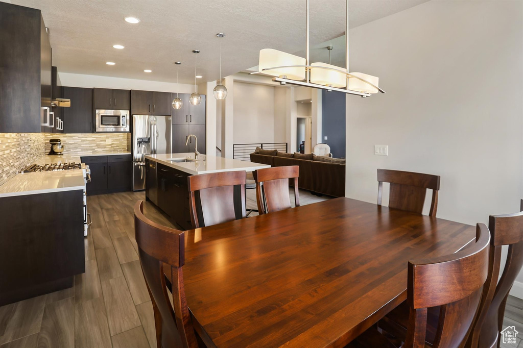 Dining space featuring dark wood finished floors and recessed lighting