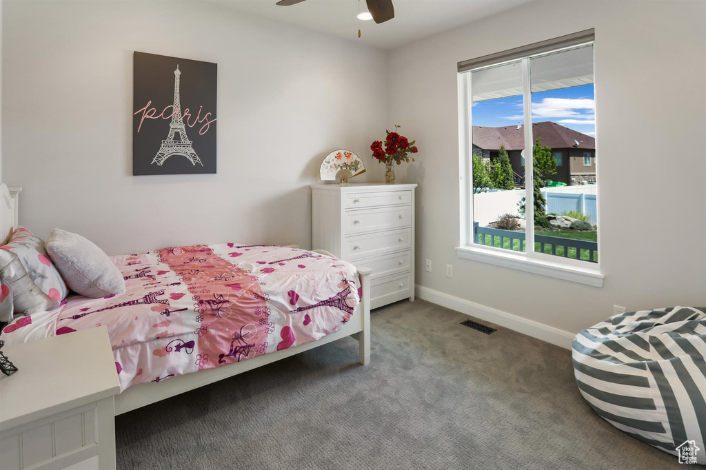 Bedroom featuring baseboards, multiple windows, visible vents, and carpet
