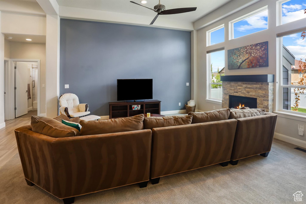 Living area with plenty of natural light and ceiling fan