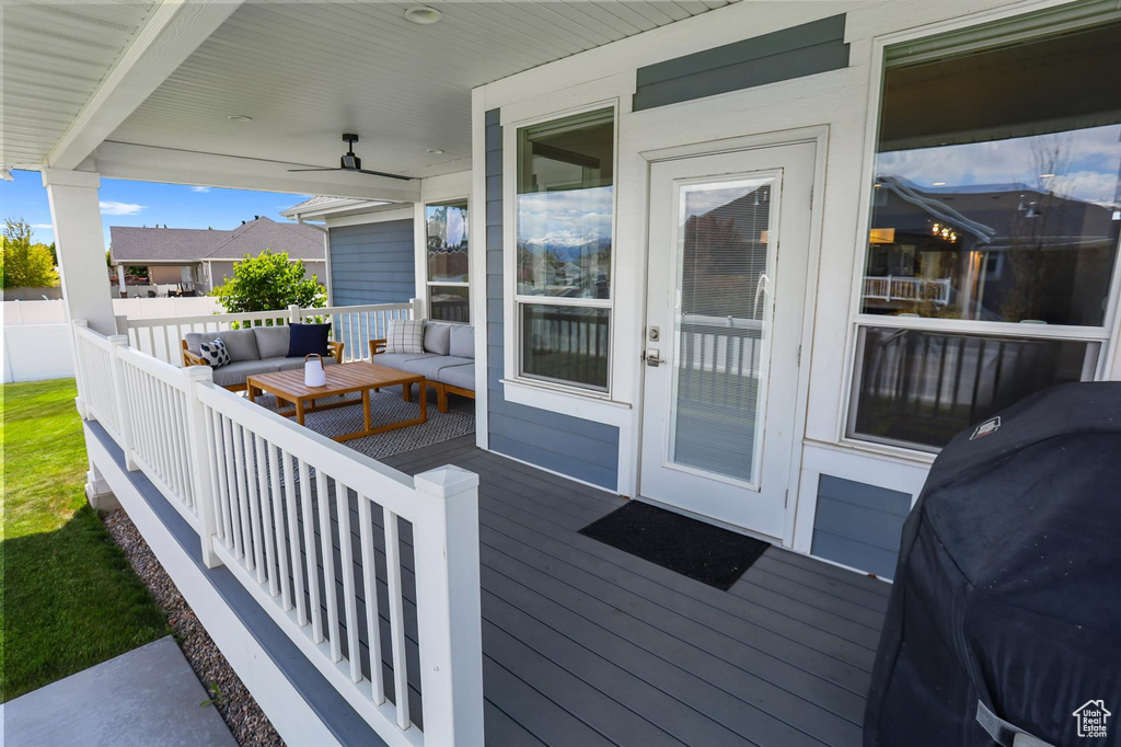Wooden deck with an outdoor living space and grilling area