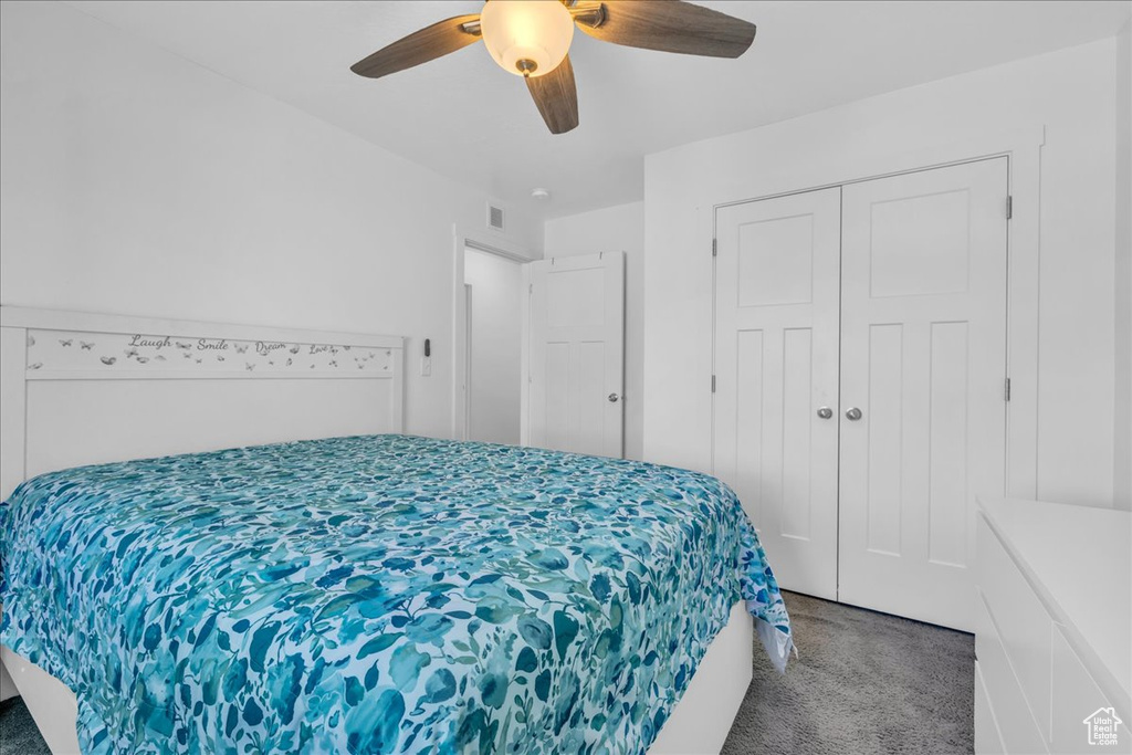 Bedroom featuring a ceiling fan, carpet flooring, a closet, and visible vents