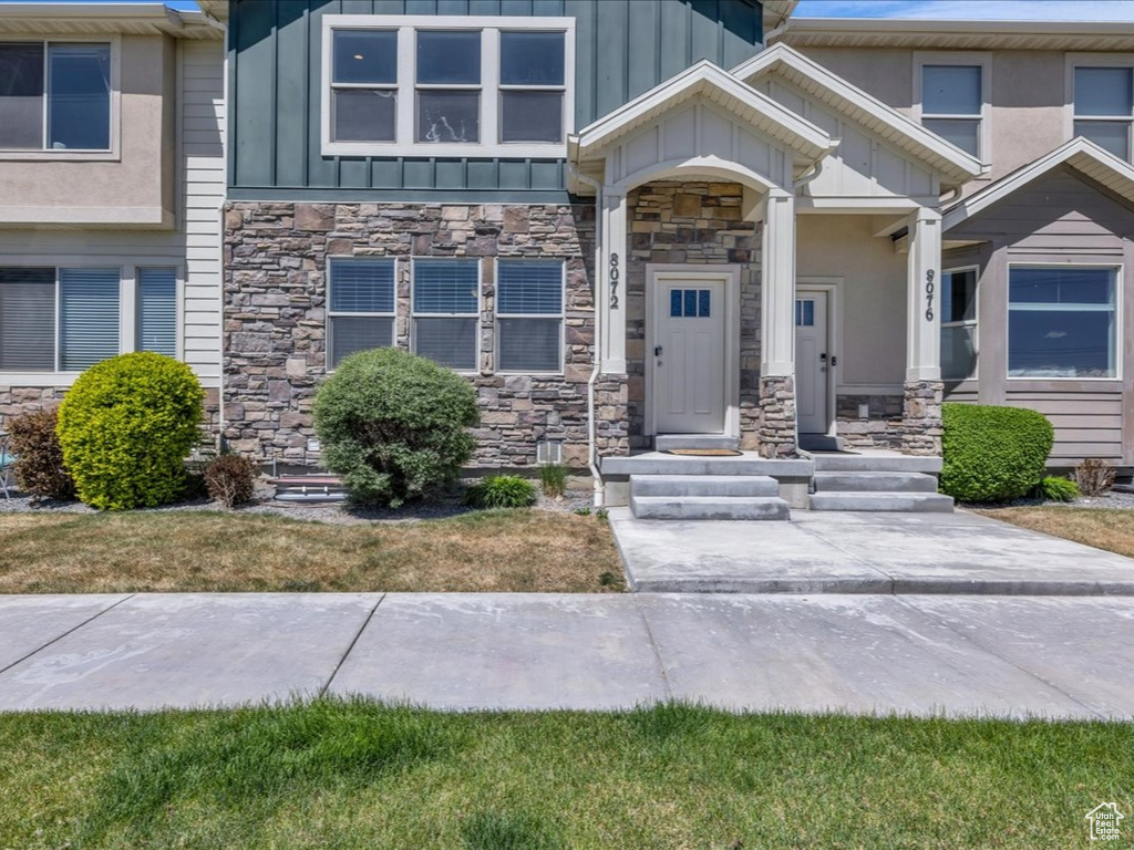 View of front of property featuring stone siding and board and batten siding