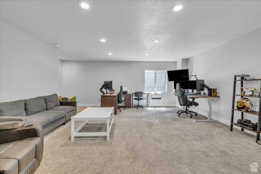 Carpeted living room featuring baseboards and recessed lighting
