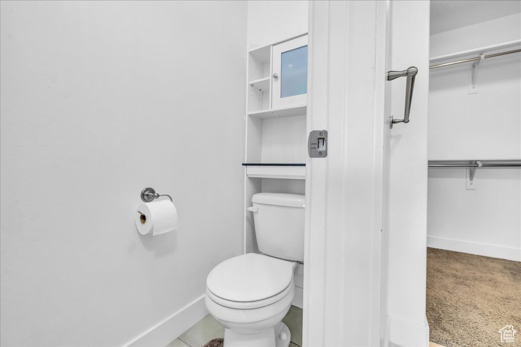 Bathroom with toilet and baseboards