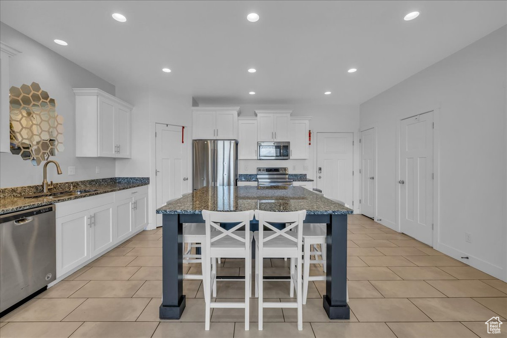 Kitchen featuring a sink, recessed lighting, white cabinets, and appliances with stainless steel finishes