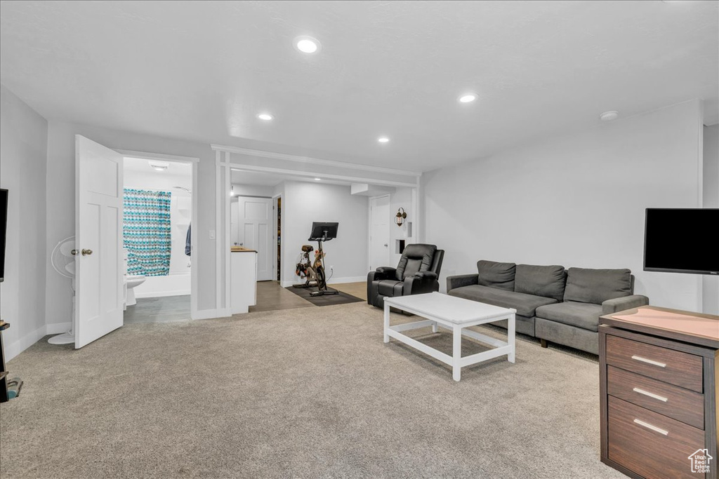 Living room featuring carpet flooring, baseboards, and recessed lighting