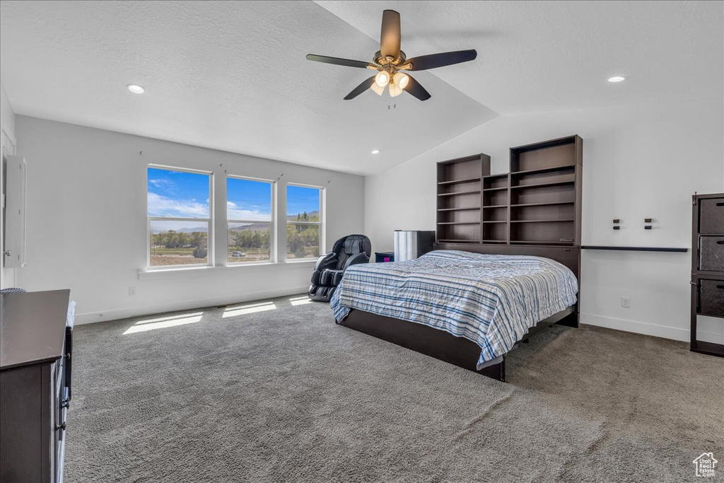 Carpeted bedroom with lofted ceiling, ceiling fan, baseboards, and recessed lighting
