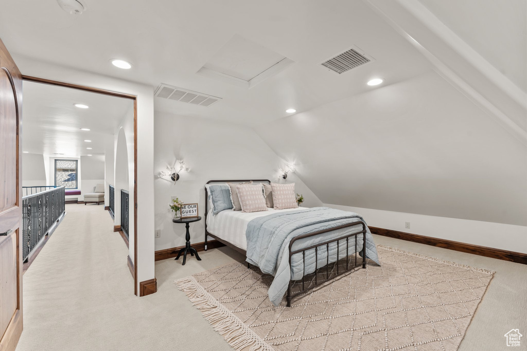 Carpeted bedroom with attic access, visible vents, vaulted ceiling, and recessed lighting