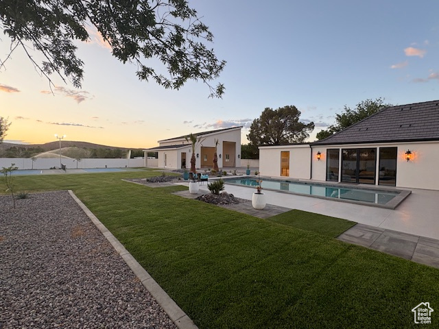 View of yard featuring a patio area, fence, and an outdoor pool
