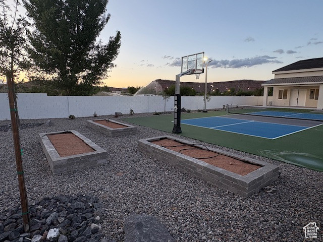View of sport court with fence and a tennis court