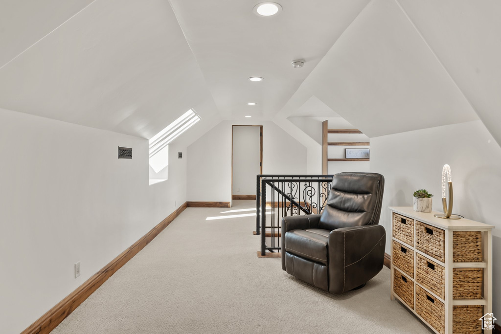 Living area with baseboards, visible vents, lofted ceiling, an upstairs landing, and carpet floors