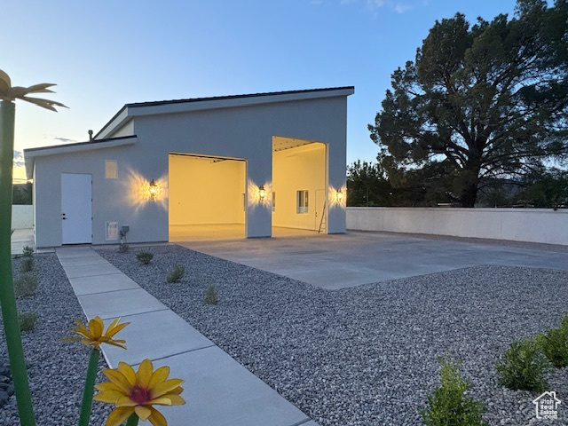 Exterior space featuring fence and stucco siding