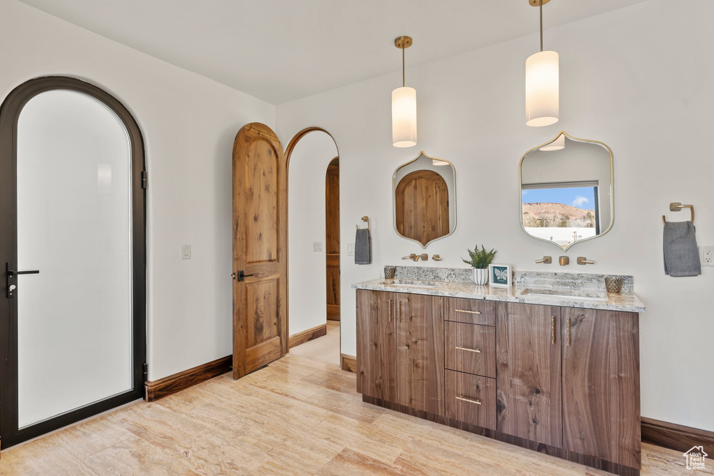 Bathroom with double vanity and baseboards