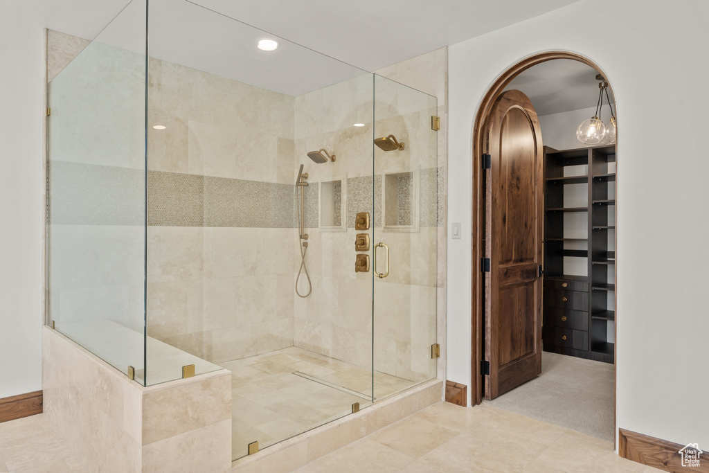 Full bath featuring a walk in closet and a shower stall