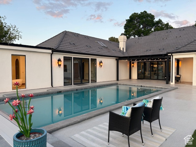 Outdoor pool with a patio area