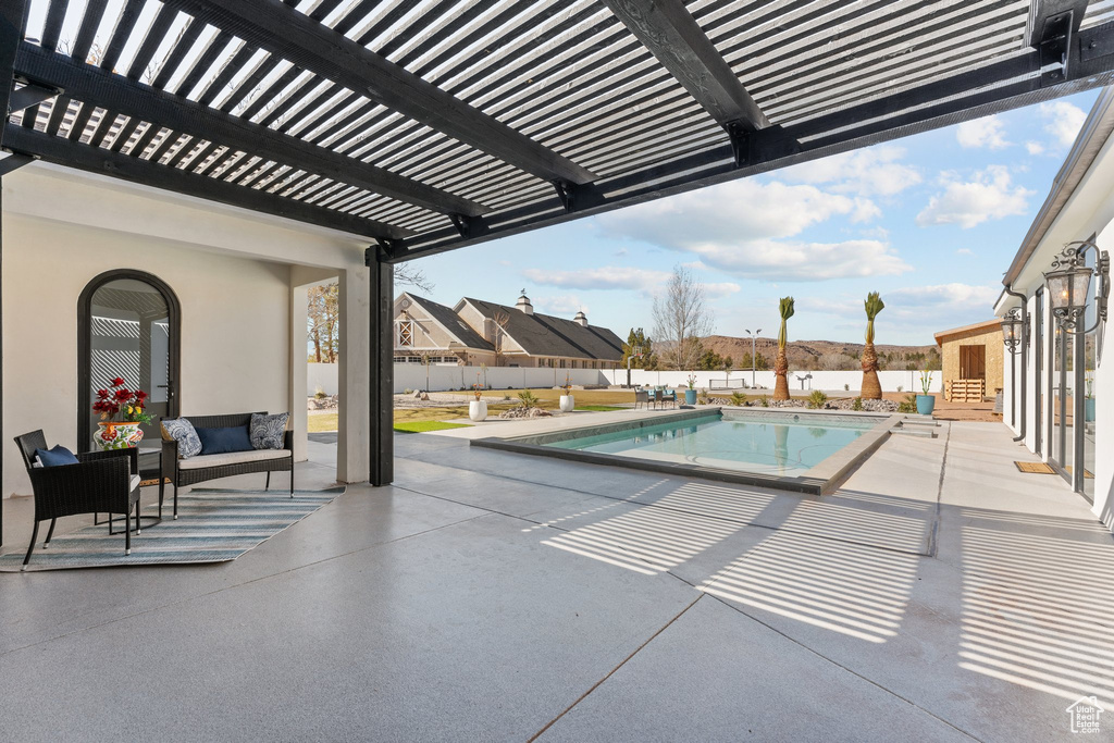 View of pool with a fenced in pool, a patio area, a fenced backyard, and a pergola