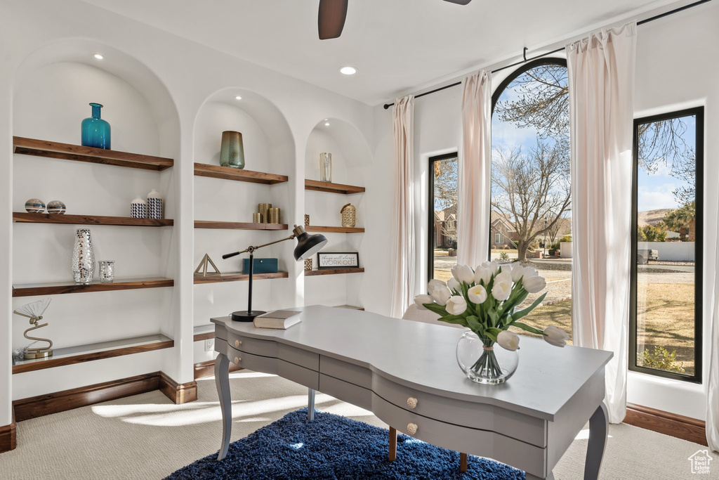 Carpeted office featuring baseboards, built in features, a ceiling fan, and recessed lighting