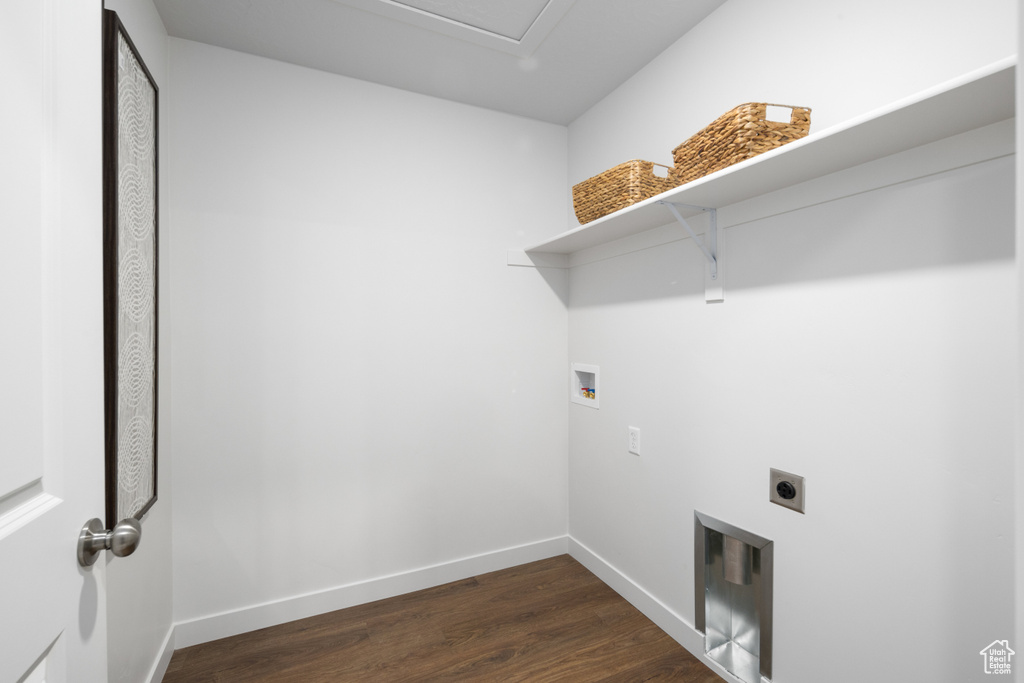 Clothes washing area featuring laundry area, dark wood finished floors, electric dryer hookup, baseboards, and hookup for a washing machine