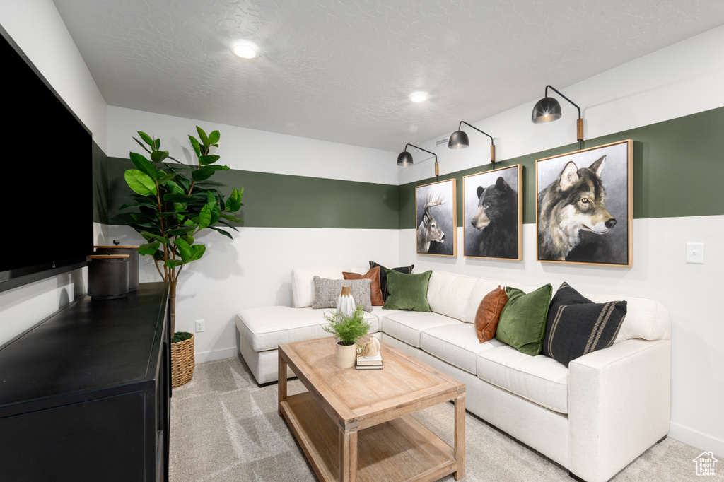 Carpeted living room with baseboards and recessed lighting