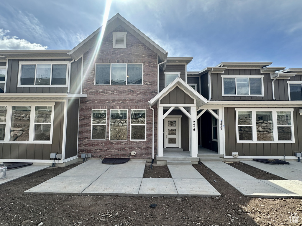 Multi unit property featuring board and batten siding and brick siding