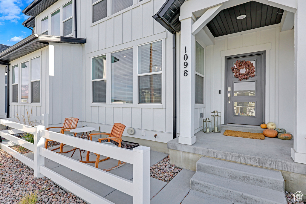 Doorway to property featuring board and batten siding