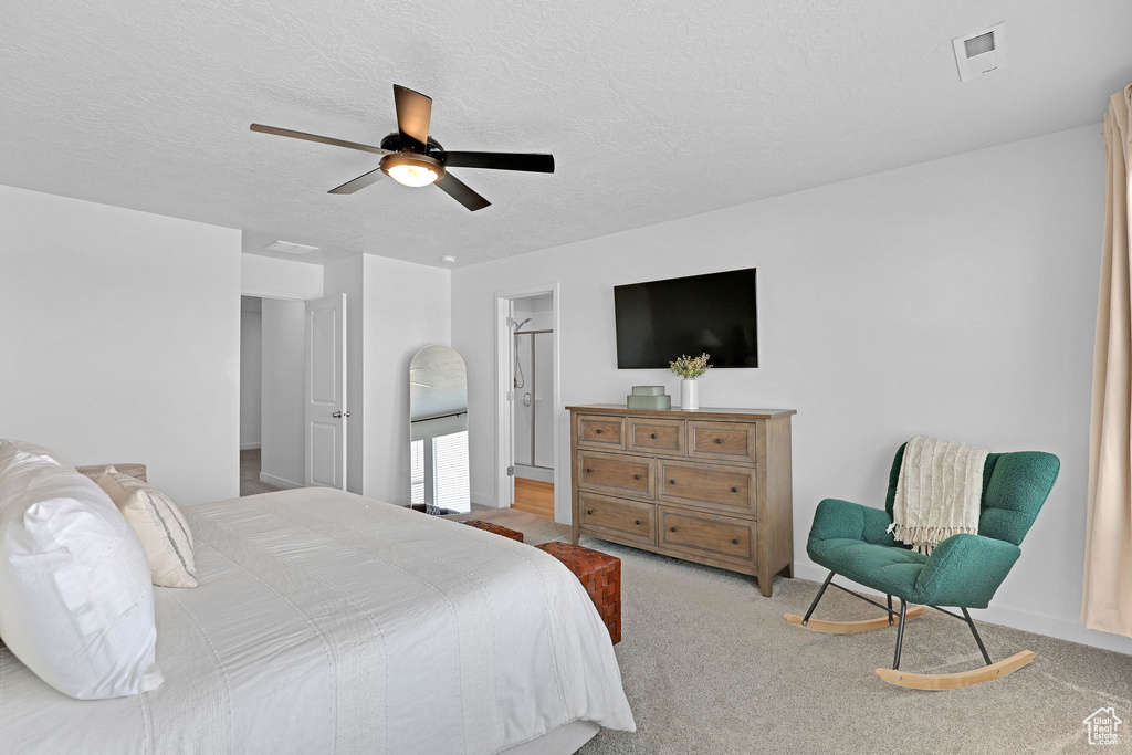 Bedroom featuring carpet, ceiling fan, and a textured ceiling