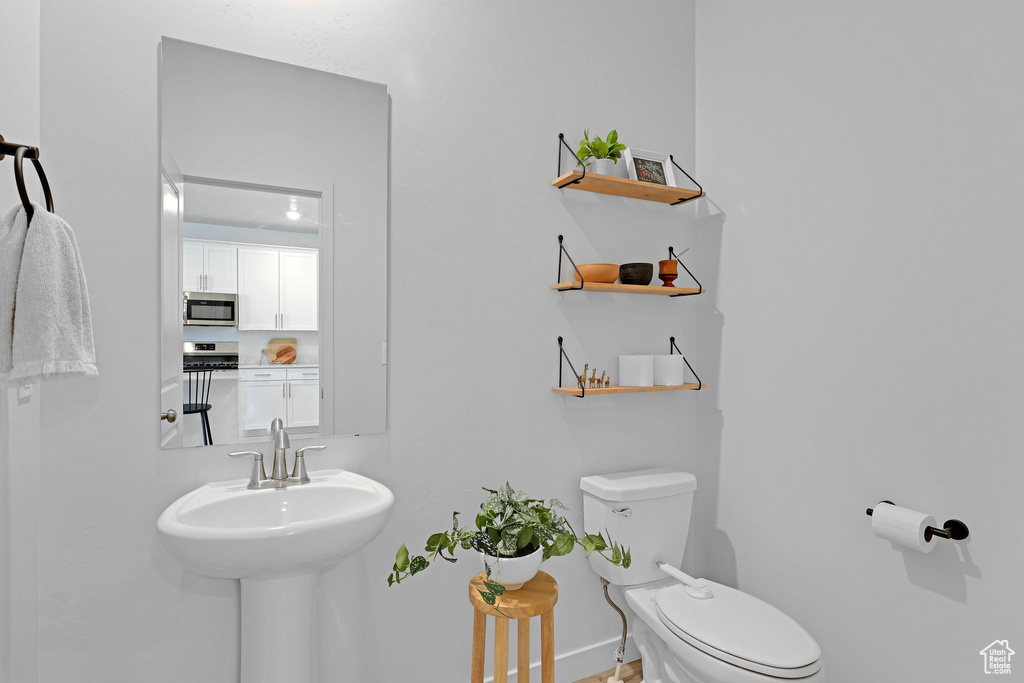 Bathroom with toilet and baseboards
