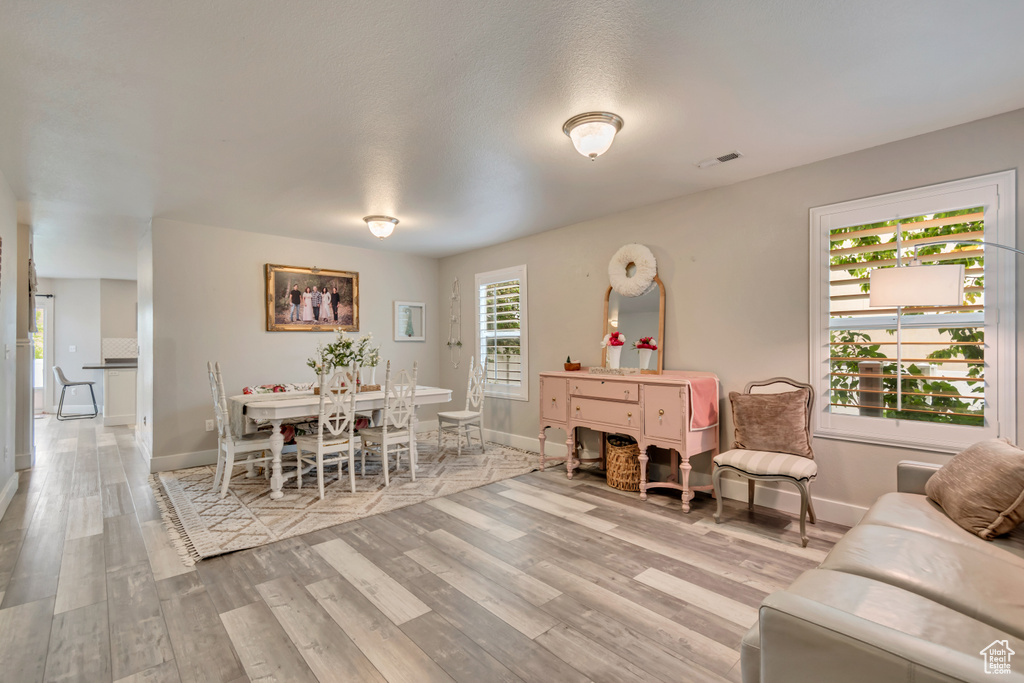 Interior space with baseboards, visible vents, and light wood-style floors