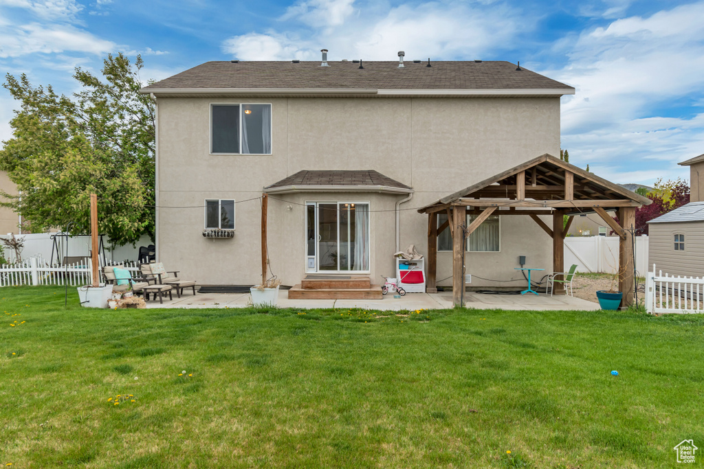 Back of house with a gazebo, a patio, stucco siding, and a fenced backyard