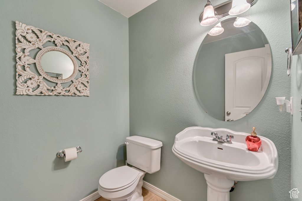 Half bathroom with toilet and a sink