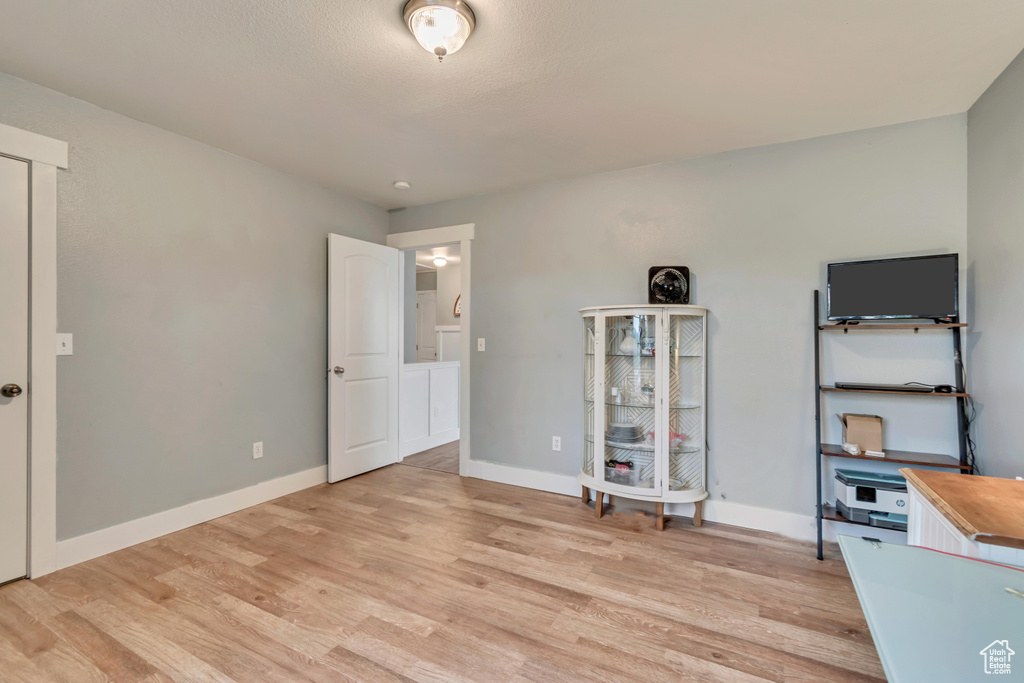 Unfurnished bedroom with baseboards and light wood-style floors